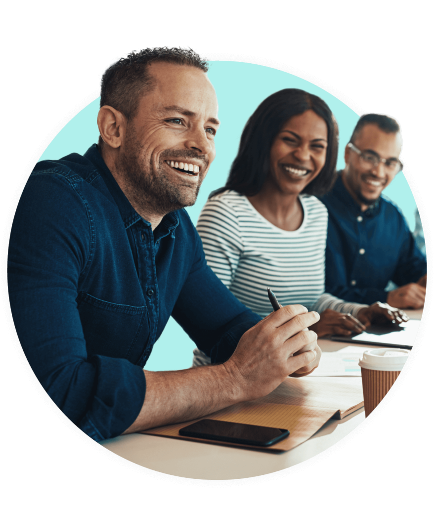 Group sitting at boardroom table together